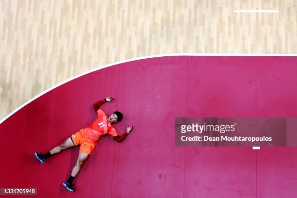 Tatsuki Yoshino of Team Japan lays on the ground after falling during the Men's Preliminary Round Group B handball match between Portugal and Japan...