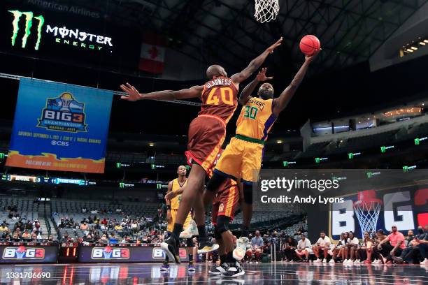 Reggie Evans of the 3 Headed Monsters attempts a shot while being guarded by Mickell Gladness of the Bivouac during BIG3 - Week Four at the American...