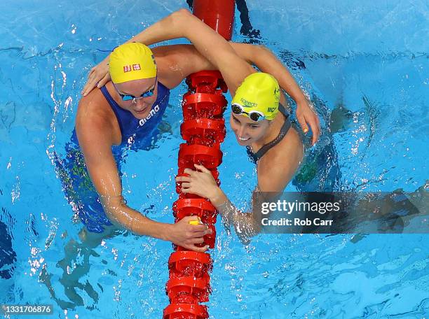 Emma McKeon of Team Australia is congratulated by Sarah Sjoestroem of Team Sweden after winning the gold medal and breaking the olympic record in the...