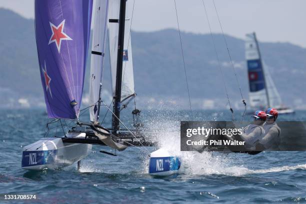 Micah Wilkinson and Erica Dawson of Team New Zealand head out to compete in the Nacra 17 Foiling class on day nine of the Tokyo 2020 Olympic Games at...