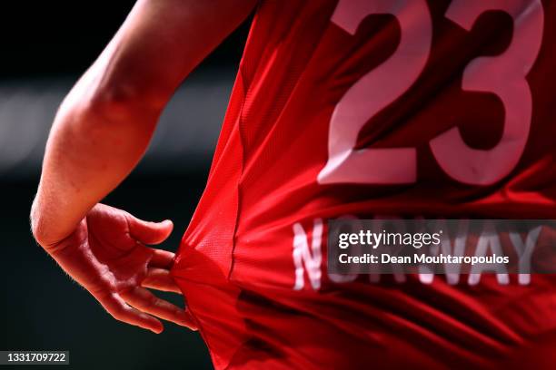 Detail shot of resin or wax sticking to her shirt is seen on the hand of Camilla Herrem of Team Norway during the Women's Preliminary Round Group A...