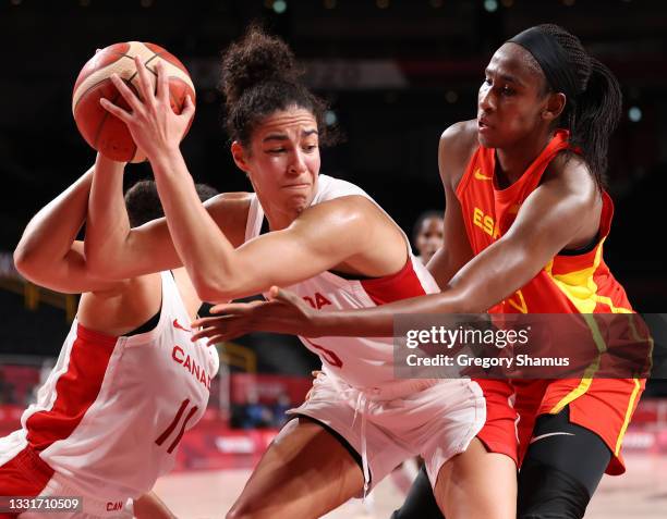Kia Nurse of Team Canada is pressured by Astou Ndour of Team Spain during the second half of a Women's Basketball Preliminary Round Group A game at...