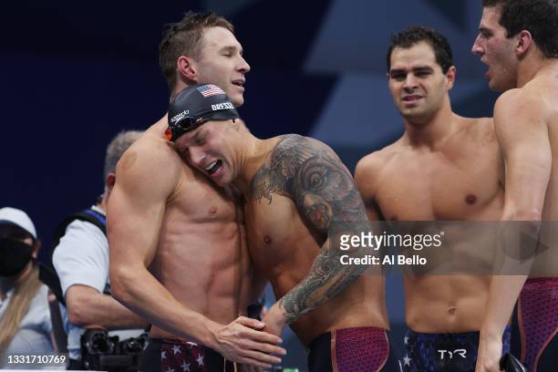 Caeleb Dressel of Team United States celebrates with teammates after winning the gold medal and setting a new world record in Men's 4 x 100m Medley...