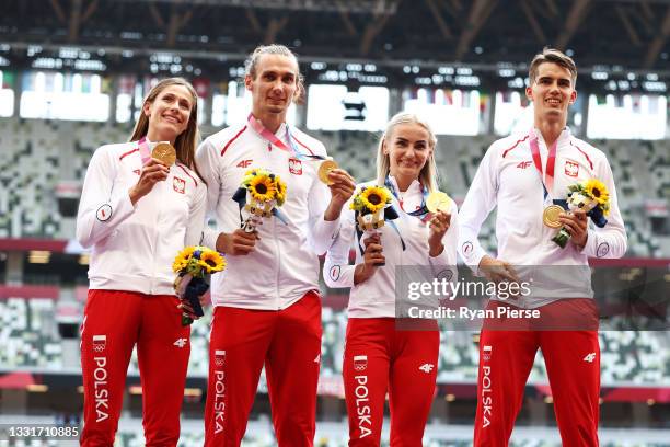 Gold medalists Natalia Kaczmarek, Karol Zalewski, Justyna Swiety-Ersetic and Kajetan Duszynski of Team Poland pose during the medal ceremony for the...