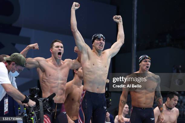 Ryan Murphy, Zach Apple and Caeleb Dressel of Team United States react after winning the gold medal and breaking the world record in the Men's 4 x...