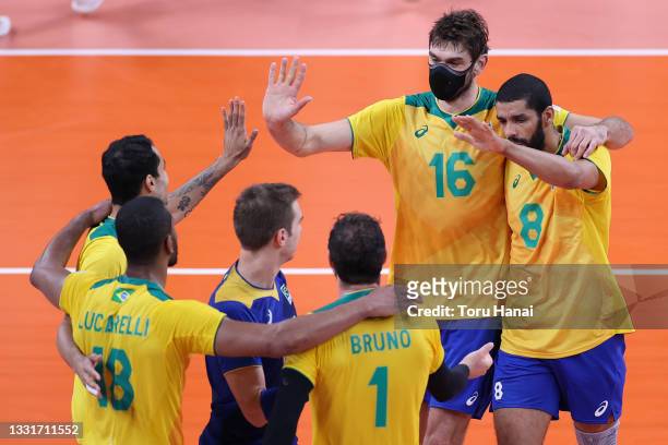 Lucas Saatkamp of Team Brazil and Wallace de Souza celebrate with teammates against Team France during the Men's Preliminary Round - Pool B...