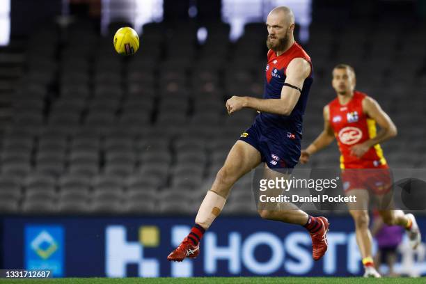 Max Gawn of the Demons kicks the ball during the round 20 AFL match between Gold Coast Suns and Melbourne Demons at Marvel Stadium on August 01, 2021...