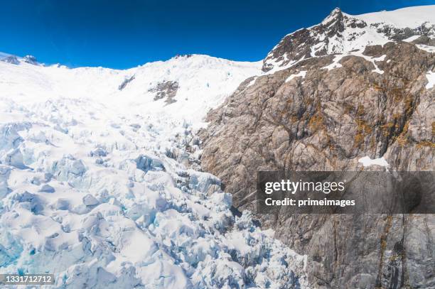 open wide mountain snow covering tour with aerial view travel trip in fox glacier town southern alps mountain valleys , new zealand. - lake matheson new zealand stock pictures, royalty-free photos & images