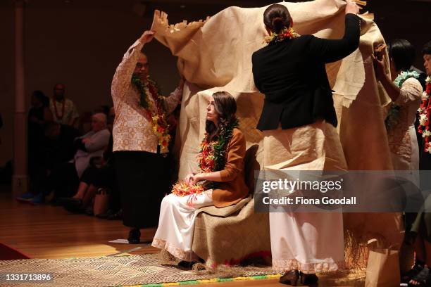 New Zealand Prime Minister Jacinda Ardern is covered by a mat of forgiveness during a service to make a formal apology to the Pacifika people...