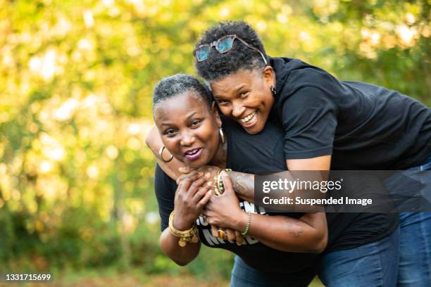 couple is laughing and play outside - lesbians flirting stock pictures, royalty-free photos & images