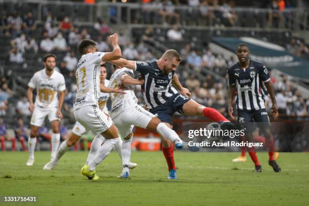 Vincent Janssen of Monterrey fights for the ball with Gerardo Moreno and Leonel López of Pumas during the 2nd round match between Monterrey and Pumas...