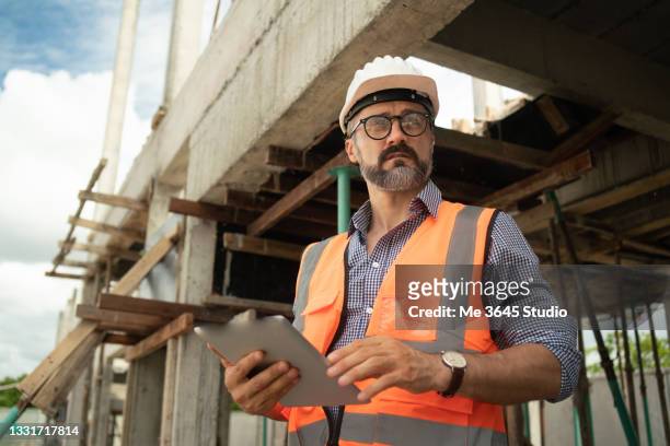 engineering man site construction work. portrait man  construction industry - building contractor stockfoto's en -beelden