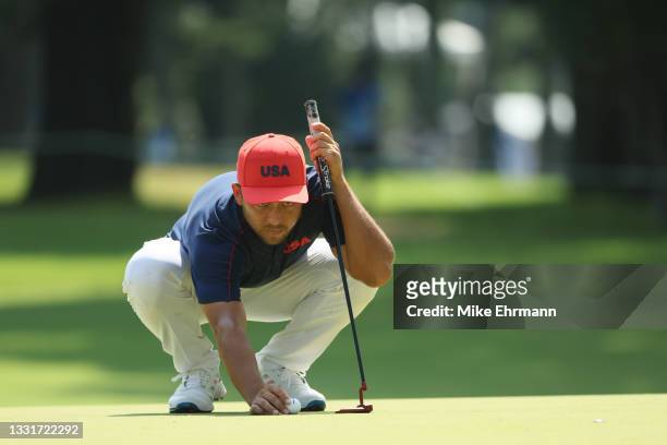 Xander Schauffele of Team United States prepares to putt on the 11th green during the final round of the Men's Individual Stroke Play on day nine of...