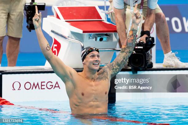 Caeleb Dressel of United States celebrates after winning the men 100m Freestyle final during the Tokyo 2020 Olympic Games at the Tokyo Aquatics...