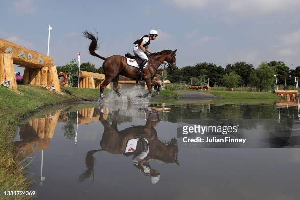 Alex Hua Tian of Team China riding Don Geniro clears a jump during the Eventing Cross Country Team and Individual on day nine of the Tokyo 2020...