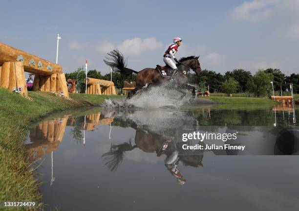 Kazuma Tomoto of Team Japan riding Vinci De La Vigne clears a jump during the Eventing Cross Country Team and Individual on day nine of the Tokyo...