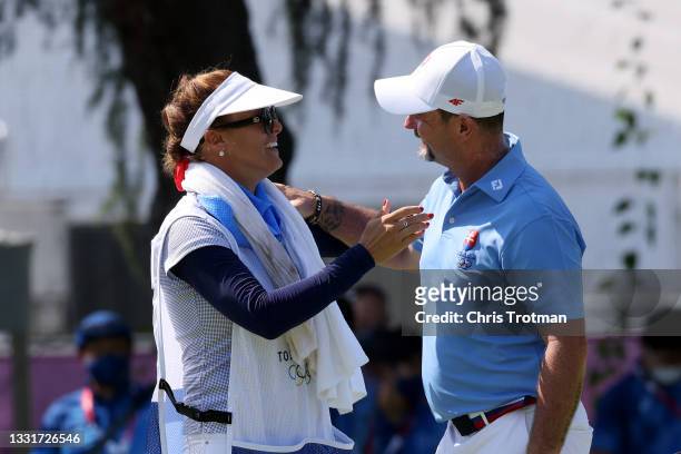 Rory Sabbatini of Team Slovakia celebrates his putt on the 18th green with caddie Martina Sabbatini during the final round of the Men's Individual...