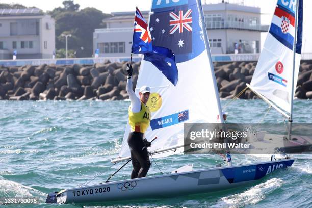 Matt Wearn of Team Australia celebrates winning gold after finishing first in the Men's Laser class on day nine of the Tokyo 2020 Olympic Games at...