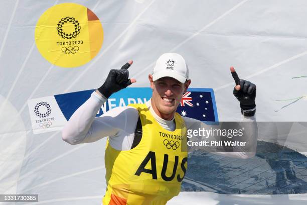 Matt Wearn of Team Australia celebrates winning gold after finishing first in the Men's Laser class on day nine of the Tokyo 2020 Olympic Games at...