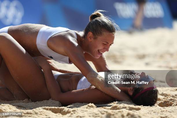 Tina Graudina of Team Latvia and Anastasija Kravcenoka celebrate after defeating Team ROC during the Women's Round of 16 beach volleyball on day nine...