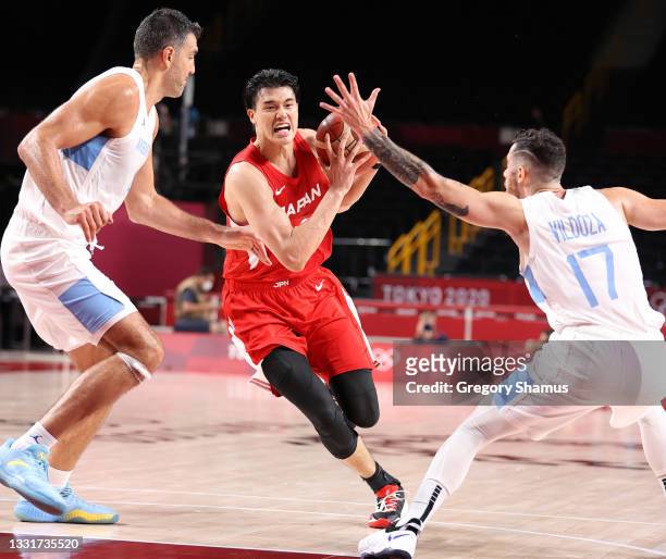 Yuta Watanabe of Team Japan drives to the basket against Luis Scola and Luca Vildoza of Team Argentina during the second half of a Men's Basketball...