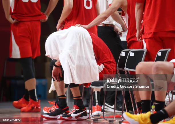 Yuta Watanabe of Team Japan sits on the bench with a towel covering his head after a loss to Argentina during a Men's Basketball Preliminary Round...
