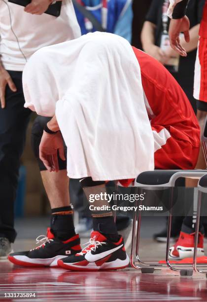 Yuta Watanabe of Team Japan sits on the bench with a towel covering his head after a loss to Argentina during a Men's Basketball Preliminary Round...