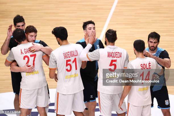 Players congratulate each other after the Men's Preliminary Round Group A handball match between Spain and Argentina on day nine of the Tokyo 2020...