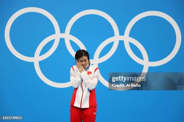 Tingmao Shi of Team China hugs the gold medal for Women's 3m Springboard on day nine of the Tokyo 2020 Olympic Games at Tokyo Aquatics Centre on...