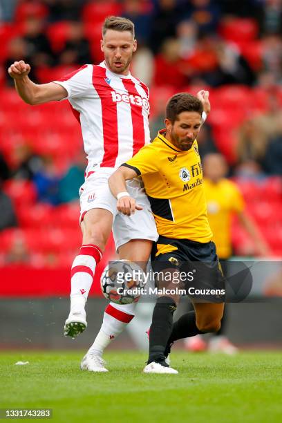 Nick Powell of Stoke City competes with Joao Moutinho of Wolverhampton Wanderers during the Pre-Season Friendly between Stoke City and Wolverhampton...