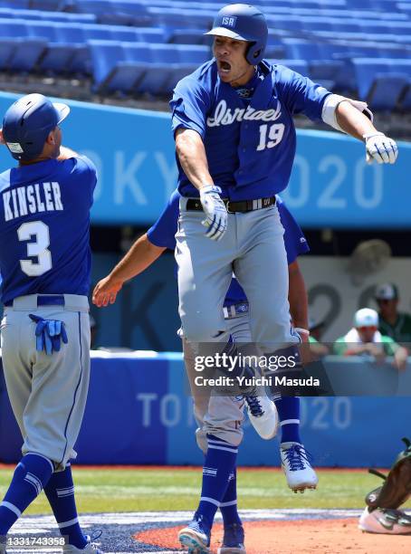 Daniel Valencia of Team Israel celebrates with Ian Kinsler after Valencia hit a three-run home run to left field in the third inning against pitcher...