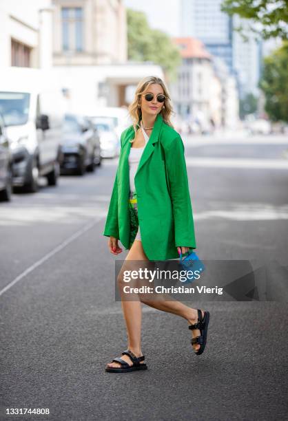 Mandy Bork is seen wearing Versace Shorts with print, white Zimmermann top, green Storets Blazer, Dior sandals, blue micro bag Hermes, Linda farrow...