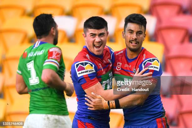 In this handout image provided by NRL Photos Enari Tuali of the Knights celebrates with team mates after scoring a try during the round 20 NRL match...