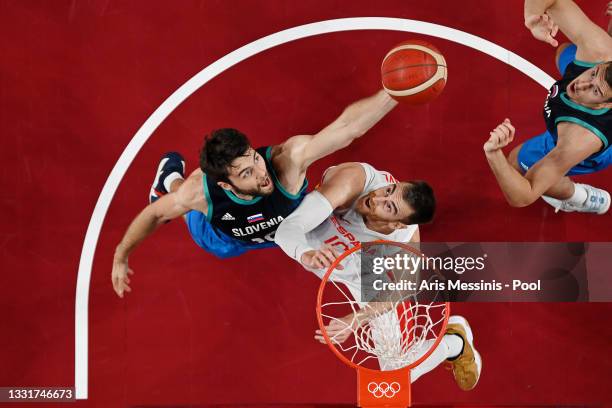 Mike Tobey of Team Slovenia and Victor Claver of Team Spain jump for a rebound during the first half of a Men's Basketball Preliminary Round Group C...