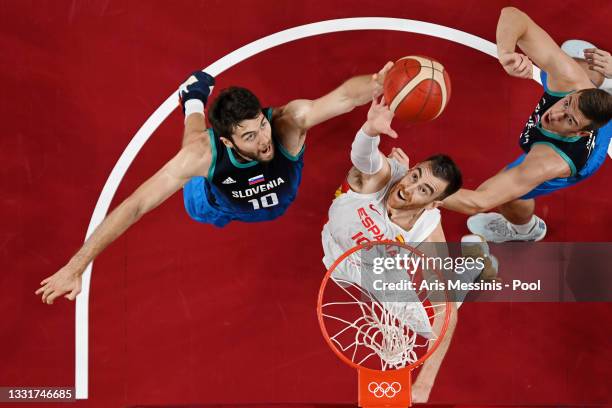 Mike Tobey of Team Slovenia and Victor Claver of Team Spain jump for a rebound during the first half of a Men's Basketball Preliminary Round Group C...