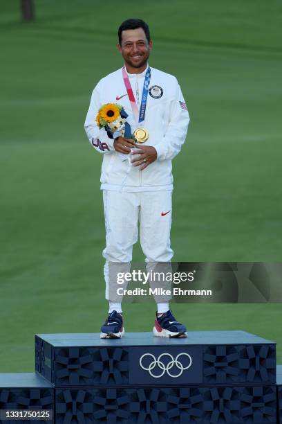 Xander Schauffele of Team United States celebrates with the gold medal during the medal ceremony after the final round of the Men's Individual Stroke...