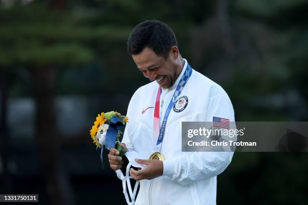 Xander Schauffele of Team United States celebrates with the gold medal during the medal ceremony after the final round of the Men's Individual Stroke...