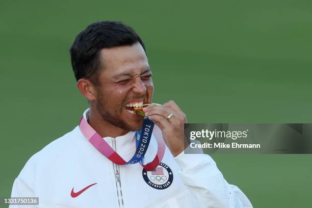 Xander Schauffele of Team United States celebrates with the gold medal during the medal ceremony after the final round of the Men's Individual Stroke...