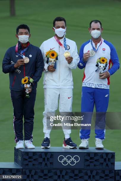 Pan of Team Chinese Taipei celebrates with the bronze medal, Xander Schauffele of Team United States with the gold medal and Rory Sabbatini of Team...