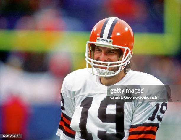 Quarterback Bernie Kosar of the Cleveland Browns smiles as he looks on from the field before the 1986 season AFC Championship Game against the Denver...