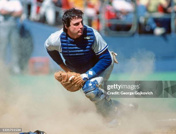 Catcher Mike Scioscia looks up from a cloud of dust after a sliding play at home plate during a game against the Pittsburgh Pirates at Three Rivers...