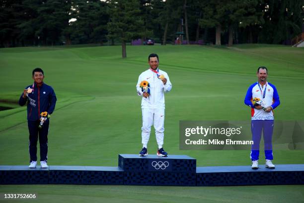 Pan of Team Chinese Taipei celebrates with the bronze medal, Xander Schauffele of Team United States with the gold medal and Rory Sabbatini of Team...