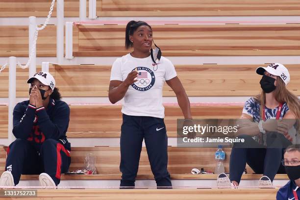 Simone Biles of Team United States watches with teammates Jordan Chiles and Grace McCallum from the stands during the Women's Vault Final on day nine...