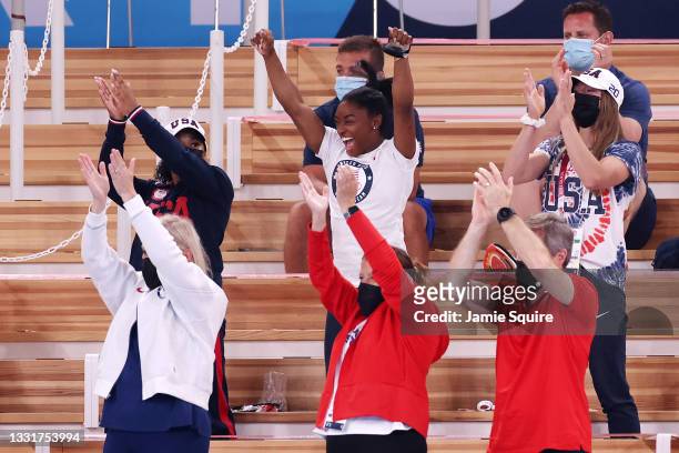 Simone Biles of Team United States cheers with teammates Jordan Chiles and Grace McCallum from the stands during the Women's Vault Final on day nine...