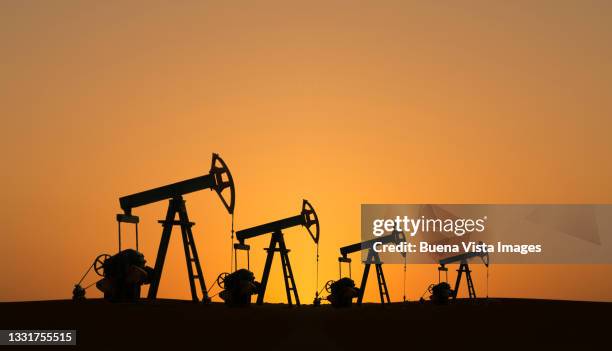 kuwait. oil pumps at sunset - kuwait stock pictures, royalty-free photos & images