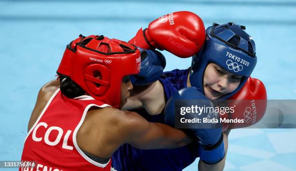 Ingrit Lorena Valencia Victoria of Team Colombia exchanges punches with Tsukimi Namiki of Team Japan during the Women's Fly quarter final on day nine...