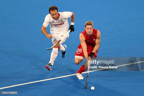 Victor Nicky B Wegnez of Team Belgium runs with the ball whilst under pressure from Alvaro Iglesias Marcos of Team Spain during the Men's...