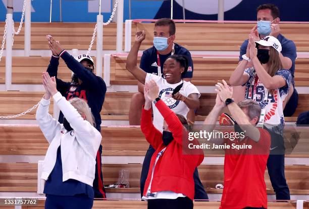 Simone Biles of Team United States cheers with teammates Jordan Chiles and Grace McCallum from the stands during the Women's Vault Final on day nine...