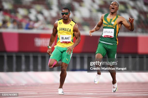 Yohan Blake of Team Jamaica and Gift Leotlela of Team South Africa react after competing in the Men's 100m Semi-Final on day nine of the Tokyo 2020...