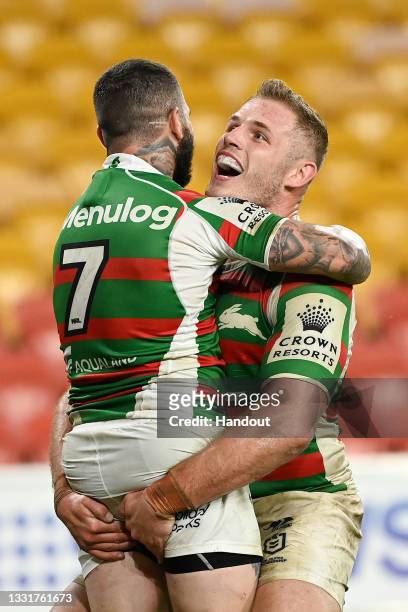In this handout image provided by NRL Photos Adam Reynolds of the Rabbitohs celebrates with team mate Thomas Burgess after scoring a try during the...